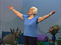 woman with white hair reaching arms out in large gesture